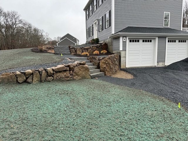 view of home's exterior featuring driveway and an attached garage