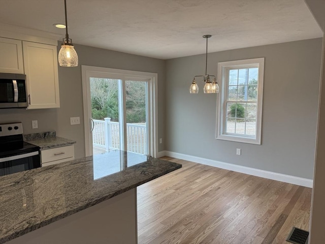 200 Pine St, Rehoboth, MA 02769 - kitchen featuring appliances with stainless steel finishes, white cabinets, light wood finished floors, stone counters, and baseboards