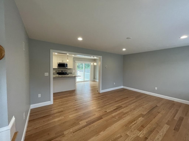 200 Pine St, Rehoboth, MA 02769 - unfurnished living room with light wood finished floors, baseboards, and recessed lighting