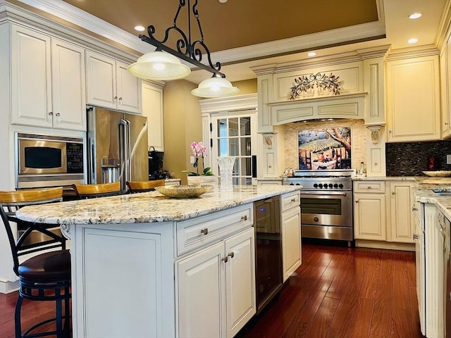 kitchen featuring light stone counters, dark wood-style floors, appliances with stainless steel finishes, ornamental molding, and a kitchen island