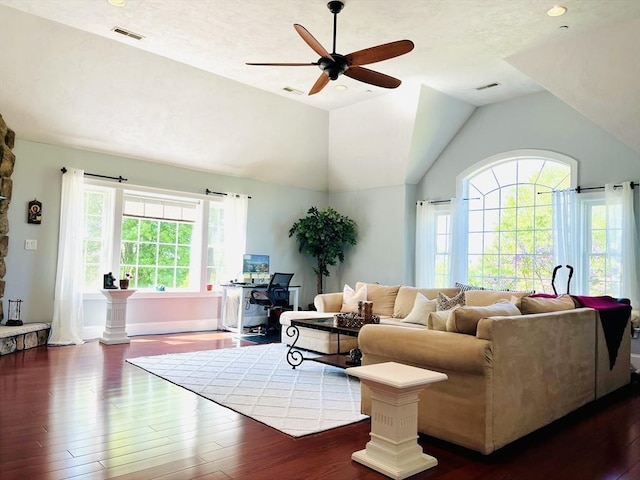 living area featuring visible vents, vaulted ceiling, and wood finished floors