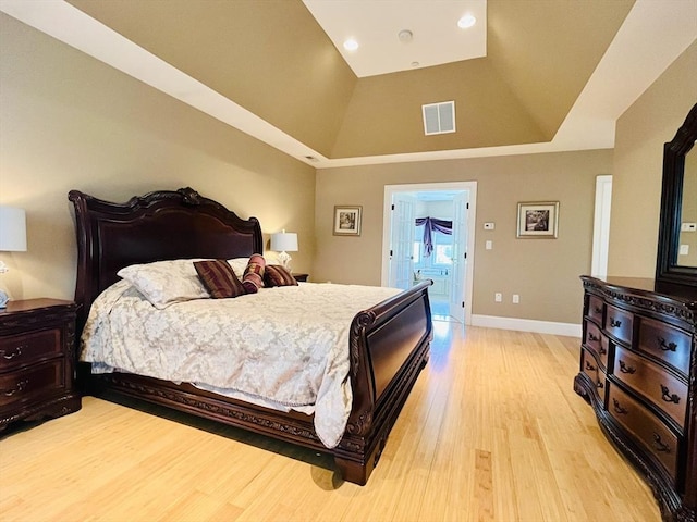 bedroom featuring light wood-type flooring, visible vents, and baseboards