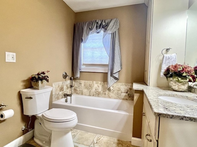 bathroom with toilet, a garden tub, baseboards, and vanity