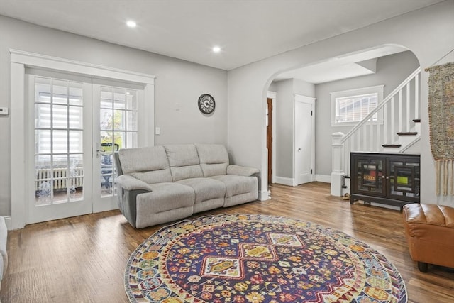 21 Vernon St, Lowell, MA 01850 - living area with plenty of natural light, arched walkways, wood finished floors, and stairway