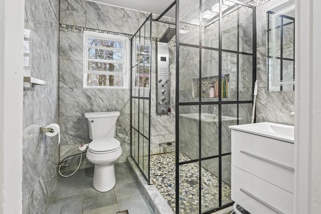 21 Vernon St, Lowell, MA 01850 - bathroom featuring a shower stall, toilet, and tile walls
