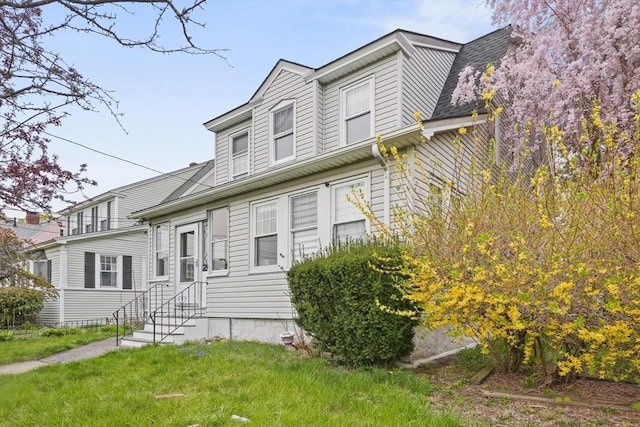 21 Vernon St, Lowell, MA 01850 - view of front of home featuring entry steps and a front lawn