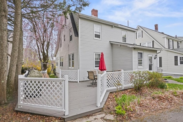 21 Vernon St, Lowell, MA 01850 - rear view of house featuring a wooden deck and a chimney