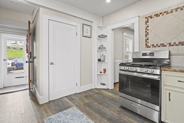 21 Vernon St, Lowell, MA 01850 - kitchen with a healthy amount of sunlight, radiator heating unit, stainless steel gas range, and dark wood-type flooring