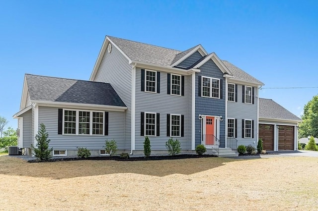 colonial home with a garage and central AC