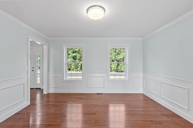 empty room with dark wood-type flooring and ornamental molding