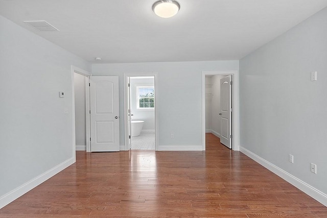 unfurnished room with wood-type flooring