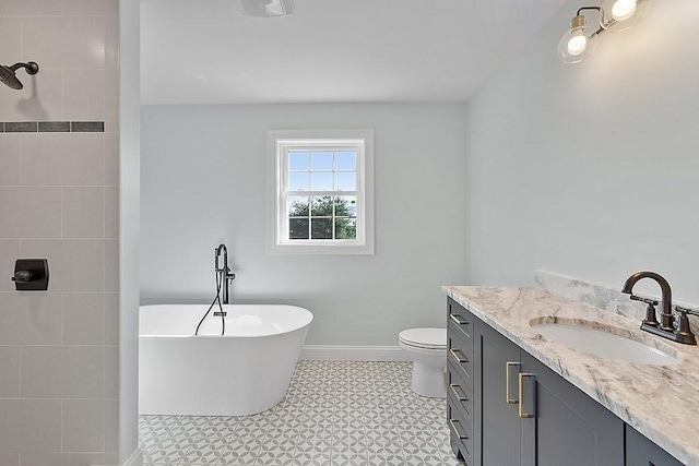 bathroom with a bathing tub, vanity, and toilet