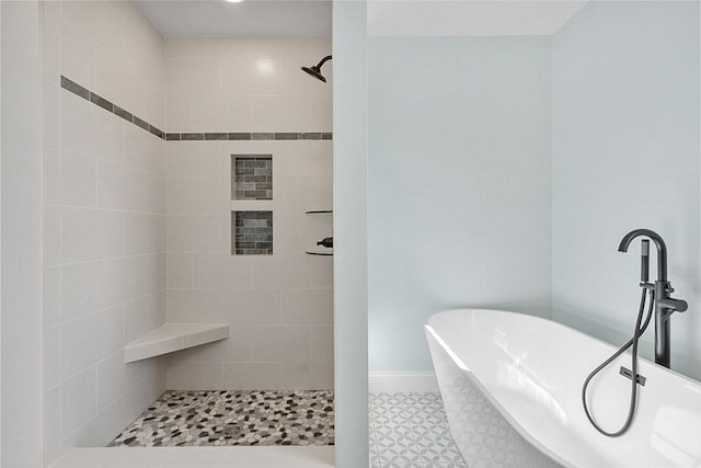 bathroom featuring shower with separate bathtub