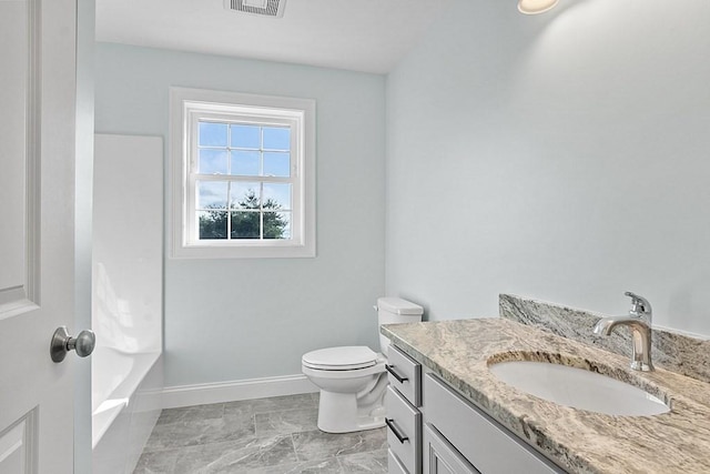 bathroom featuring vanity and toilet