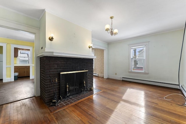 unfurnished living room featuring a baseboard heating unit, crown molding, wood finished floors, and a healthy amount of sunlight