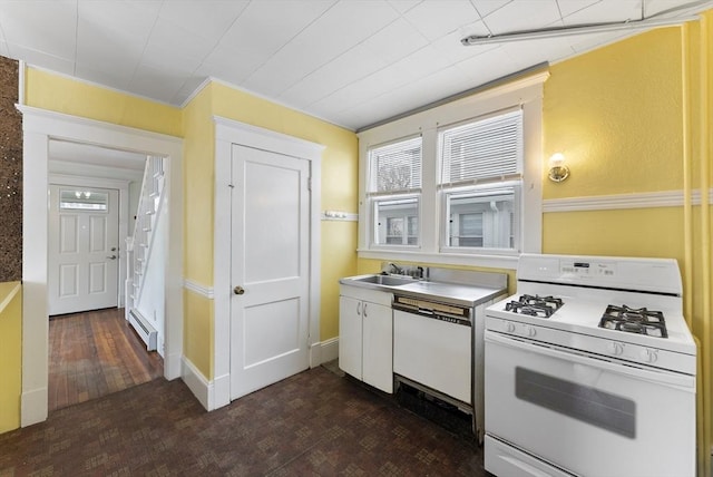 kitchen featuring white appliances, baseboards, dark wood-type flooring, a baseboard heating unit, and a sink