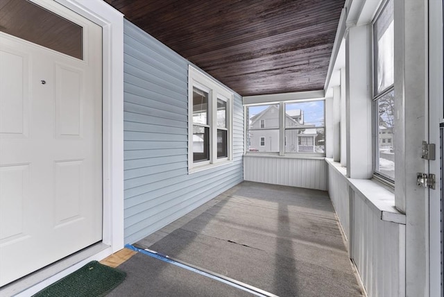 unfurnished sunroom featuring wood ceiling