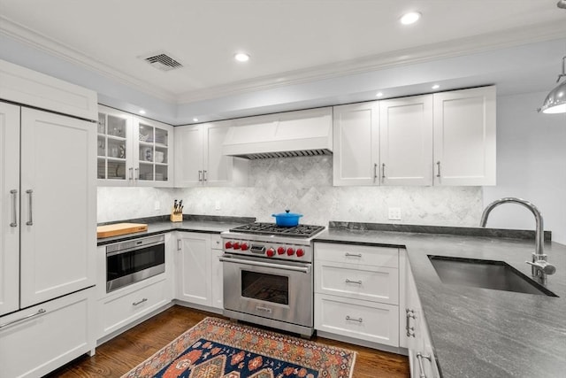 15 Hancock St Unit 1, Boston, MA 02114 - kitchen featuring high end appliances, a sink, custom range hood, ornamental molding, and white cabinetry