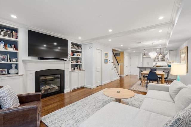 15 Hancock St Unit 1, Boston, MA 02114 - living room with wood finished floors, stairs, ornamental molding, baseboards, and a glass covered fireplace