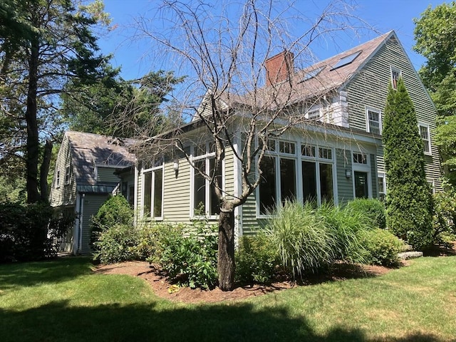 view of home's exterior with a yard