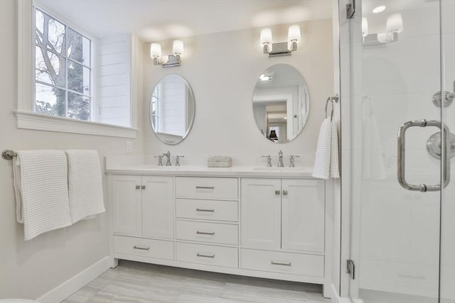 bathroom featuring an enclosed shower and vanity