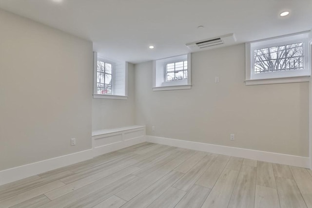 basement with light hardwood / wood-style flooring