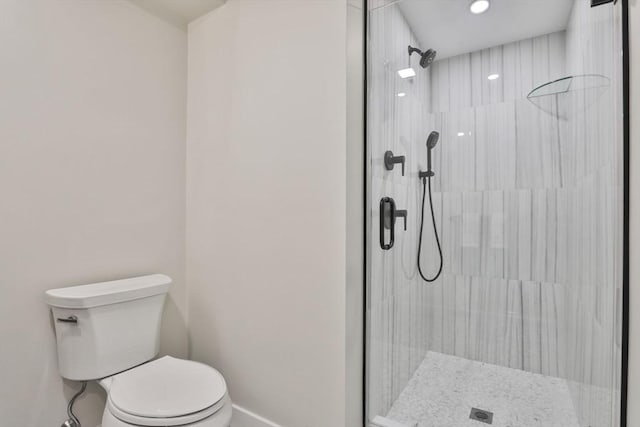 bathroom featuring toilet and an enclosed shower