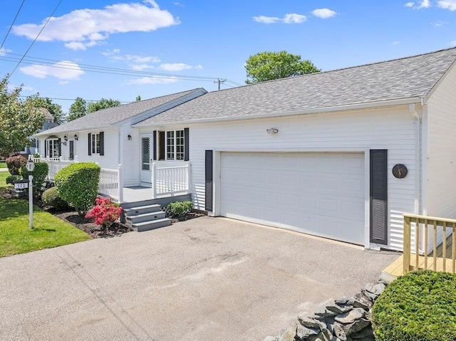 ranch-style home with covered porch and a garage