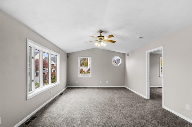 unfurnished room with dark colored carpet, ceiling fan, and lofted ceiling