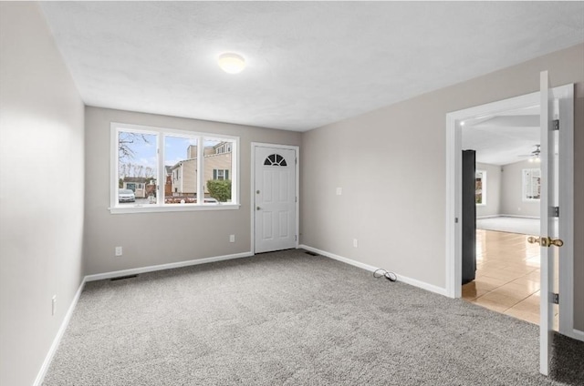 carpeted empty room featuring ceiling fan