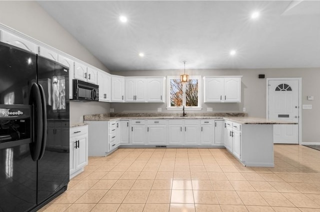 kitchen with pendant lighting, lofted ceiling, black appliances, kitchen peninsula, and white cabinetry