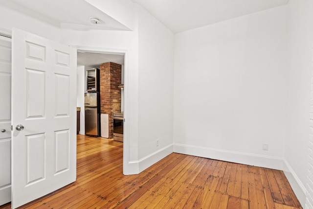 spare room with hardwood / wood-style floors