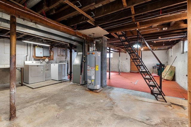 unfinished below grade area with stairs, separate washer and dryer, and water heater