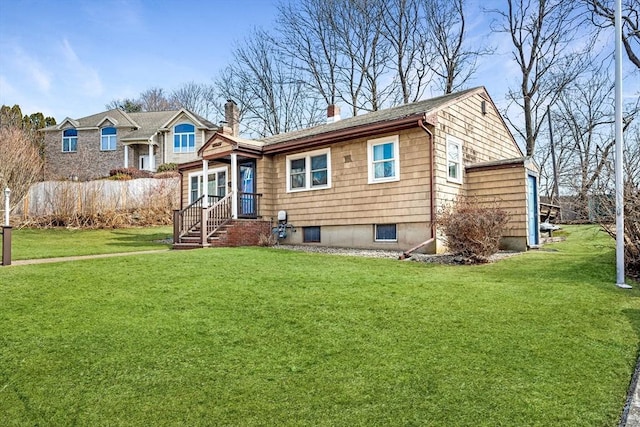 view of front of house featuring a chimney and a front lawn