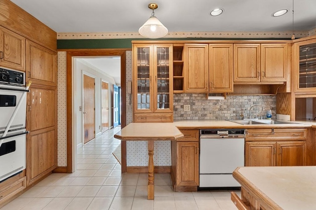 kitchen featuring a sink, wallpapered walls, light countertops, white appliances, and open shelves