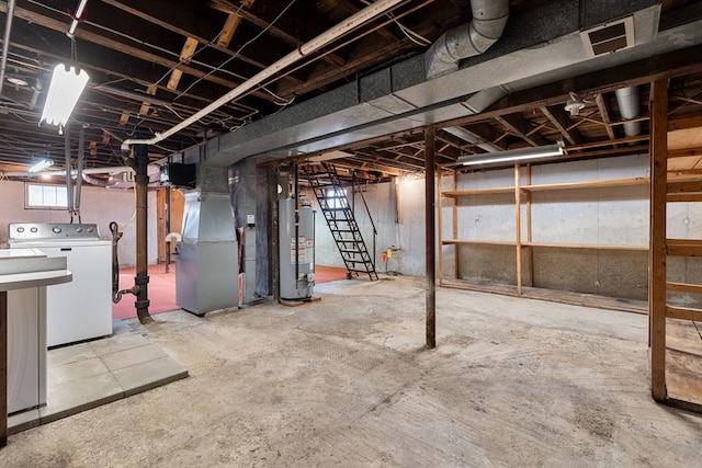 basement with heating unit, washer / dryer, and gas water heater