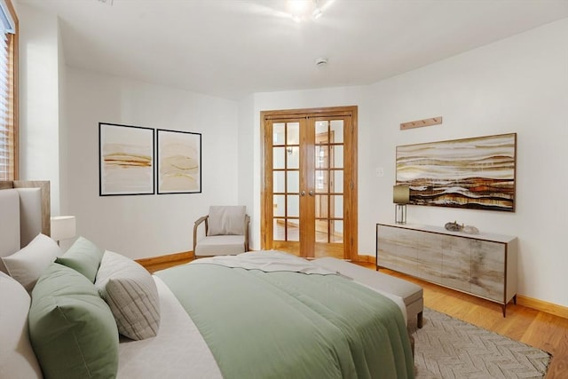 bedroom featuring light wood-type flooring, french doors, and baseboards