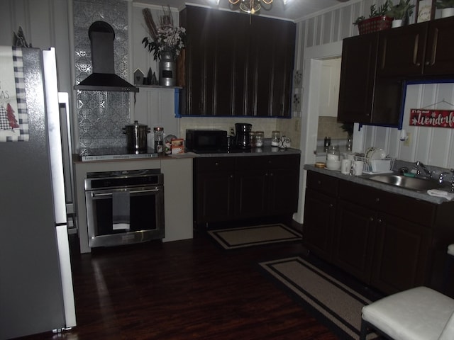 kitchen featuring stainless steel oven, dark wood-type flooring, ventilation hood, white refrigerator, and decorative backsplash