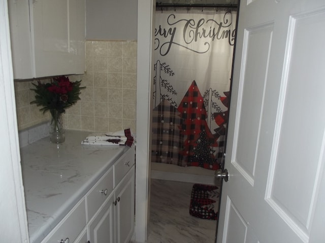 bathroom featuring vanity and tile walls