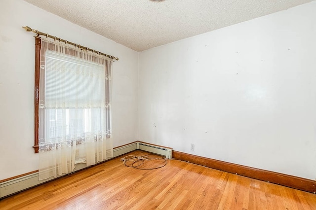 unfurnished room featuring a textured ceiling and hardwood / wood-style flooring