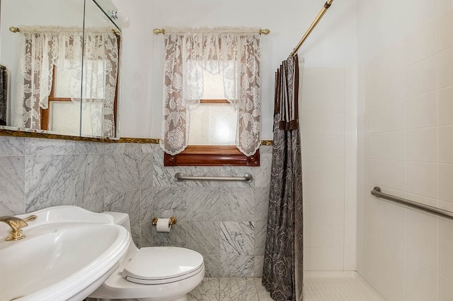 bathroom featuring a shower with curtain, sink, tile patterned flooring, toilet, and tile walls