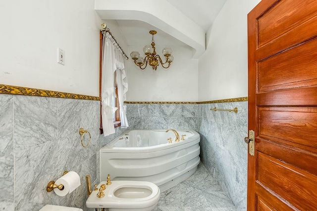 bathroom with a notable chandelier, a washtub, tile walls, and a bidet