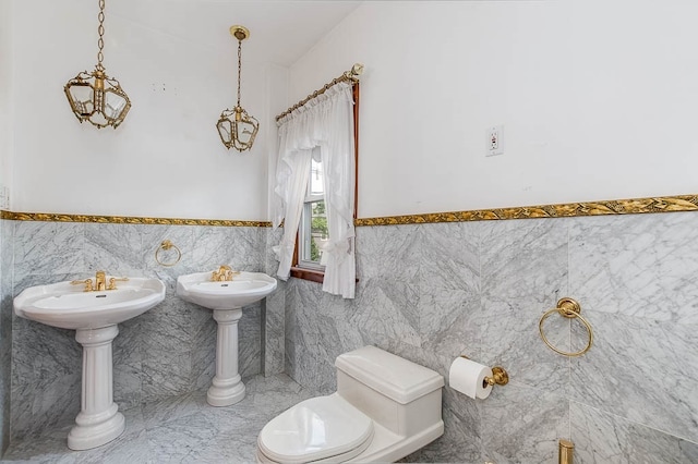 bathroom with toilet and tile walls