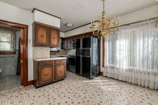 kitchen with pendant lighting, an inviting chandelier, tasteful backsplash, dark brown cabinetry, and stainless steel appliances