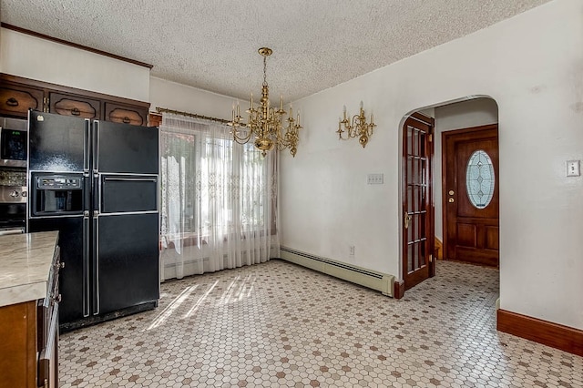 unfurnished dining area with a textured ceiling, an inviting chandelier, and baseboard heating