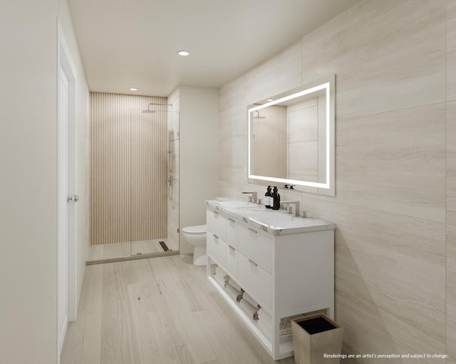 full bathroom with a shower stall, toilet, recessed lighting, wood finished floors, and vanity