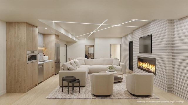 living area featuring recessed lighting, light wood-type flooring, and a large fireplace