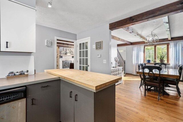 230 W St, Paxton, MA 01612 - kitchen featuring dishwasher, light wood-style floors, a peninsula, a chandelier, and wood counters