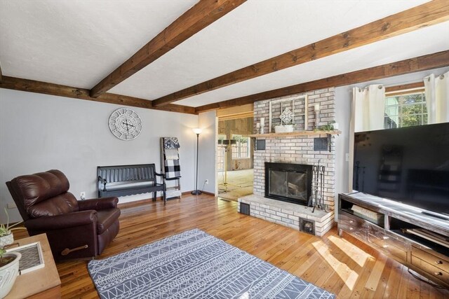 230 W St, Paxton, MA 01612 - living room with wood-type flooring, a brick fireplace, beamed ceiling, and baseboards