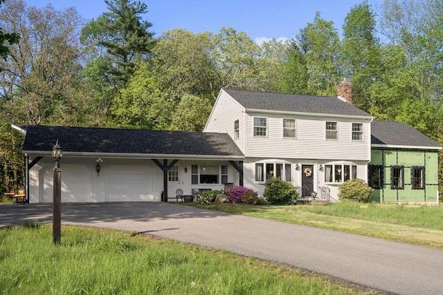 230 W St, Paxton, MA 01612 - colonial house featuring a chimney, driveway, an attached garage, roof with shingles, and a front yard